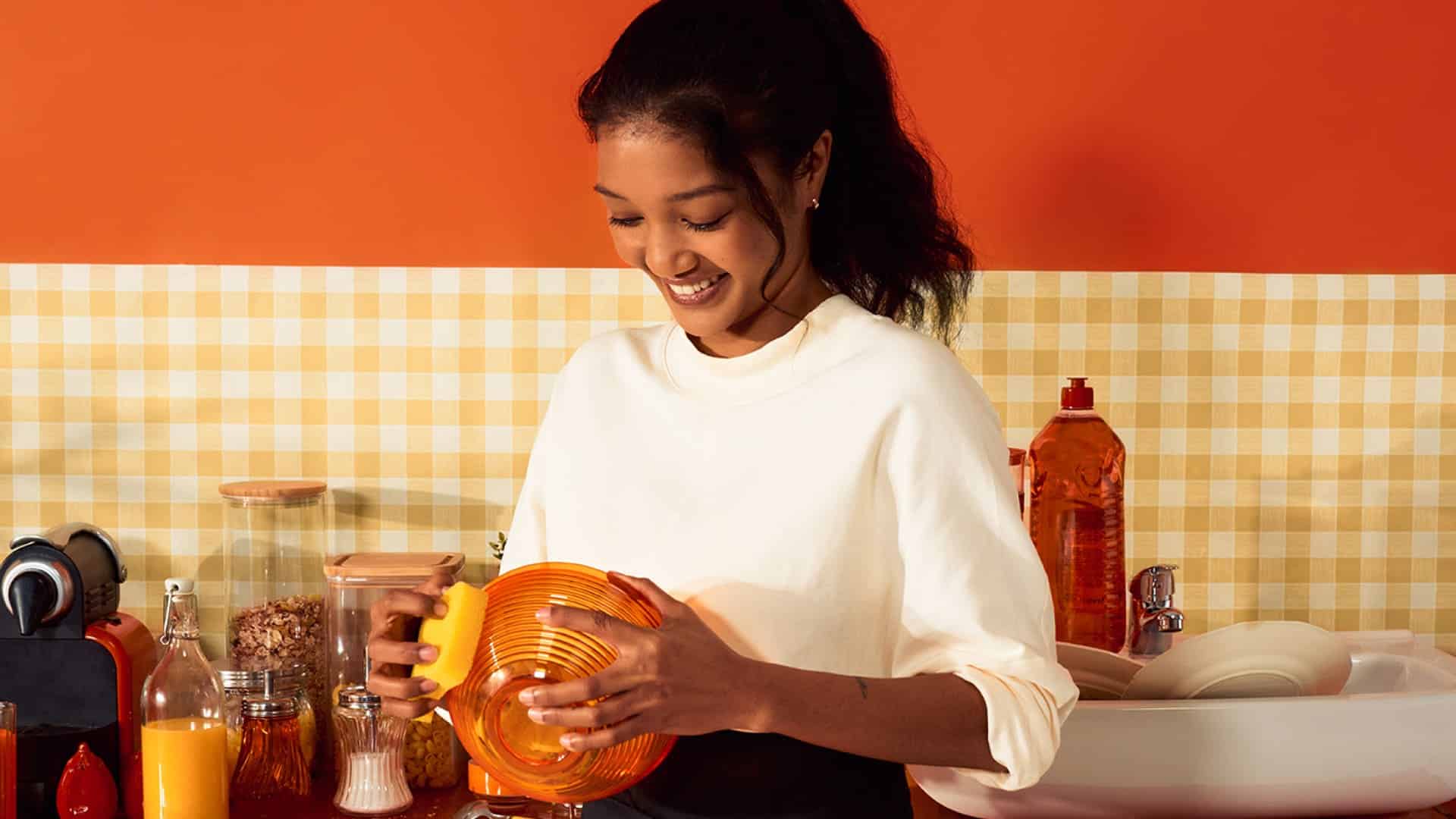 Flat cleaning services - domestic cleaner cleaning an orange bowl